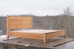 Platform Bed with paneled headboard and tapered posts side view
