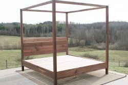 angled front view walnut canopy bed with square rails