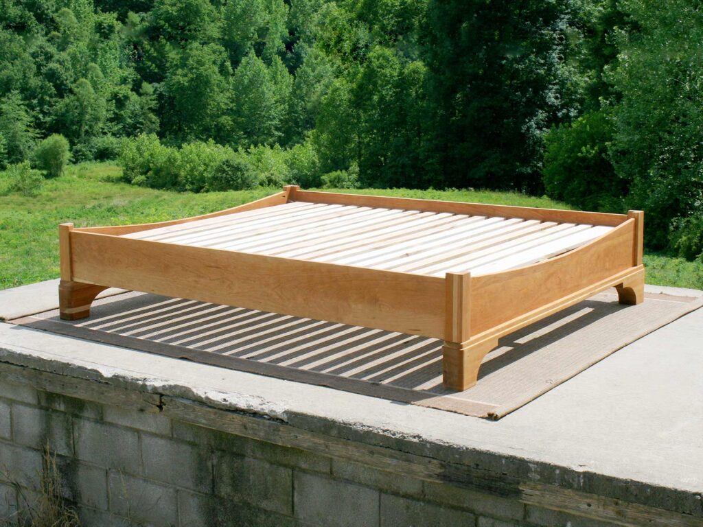 Platform Bed with large block feet and arched ends side view