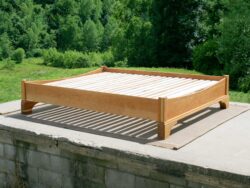 Platform Bed with large block feet and arched ends side view