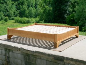 Platform Bed with large block feet and arched ends side view