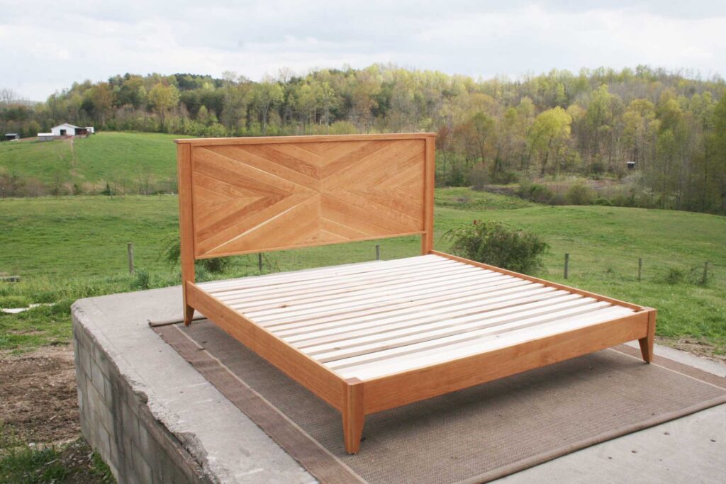 low bed with legs and herringbone headboard