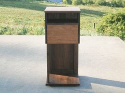 Overhanging table with drawer, shelf and support bar front view