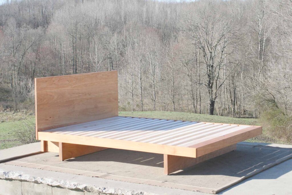 cantilever platform bed with headboard side view Maple